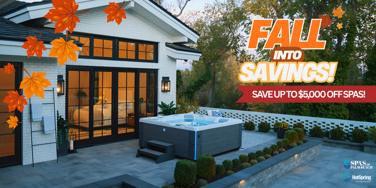 A hot tub on a stone patio outside a modern white house, with autumn leaves and large promotional text reading 'FALL INTO SAVINGS! SAVE UP TO $5,000 OFF SPAS!' and a HotSpring logo in the corner.